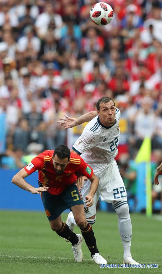 El jugador Sergio Busquets (i), de Espa?a, disputa el balón con Artem Dzyuba (d), de Rusia, durante el partido de octavos de final de la Copa Mundial de la FIFA Rusia 2018, en Moscú, Rusia, el 1 de julio de 2018. (Xinhua/Cao Can)