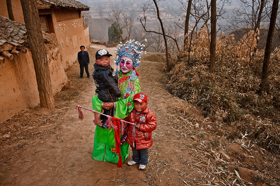 Un actor de Shehuo con sus dos hijos. [Foto: Wu Xiaopeng/cpanet.org.cn]