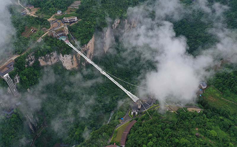 Maravilloso puente de cristal entre océanos de nubes