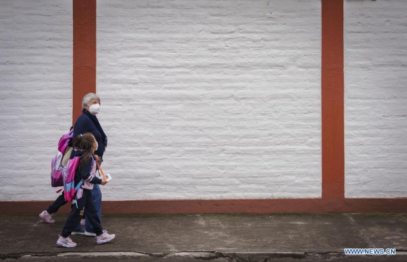 QUITO, 14 marzo, 2022 (Xinhua) -- Una mujer camina con sus nietas por una calle luego de clases presenciales, en Quito, capital de Ecuador, el 14 de marzo de 2022. Los estudiantes ecuatorianos volvieron el lunes en su totalidad a las clases presenciales sin restricciones de aforo y en todos los niveles de educación tras dos a?os de pandemia del nuevo coronavirus (COVID-19) en el país. (Xinhua/Santiago Armas)